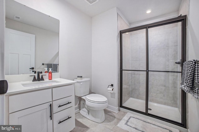 full bathroom with vanity, a shower stall, toilet, and baseboards