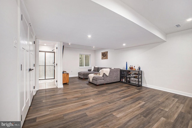 interior space with dark wood-style floors, recessed lighting, visible vents, and baseboards