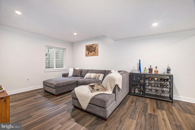 living area with recessed lighting, baseboards, and wood finished floors