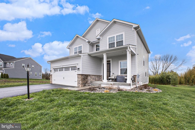 view of front of house featuring stone siding, aphalt driveway, a front lawn, and a porch