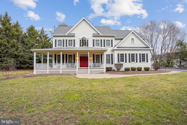 view of front of house with covered porch, a standing seam roof, metal roof, and a front yard