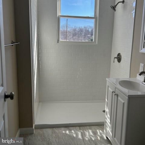 bathroom featuring vanity and a shower stall