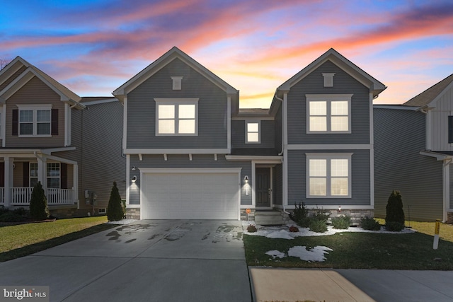 traditional-style home featuring a garage and concrete driveway