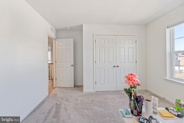 interior space featuring a healthy amount of sunlight, carpet, and baseboards