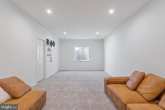 living area with recessed lighting, light colored carpet, and baseboards