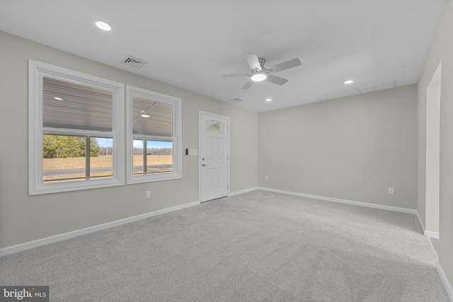 empty room featuring recessed lighting, carpet flooring, visible vents, and baseboards