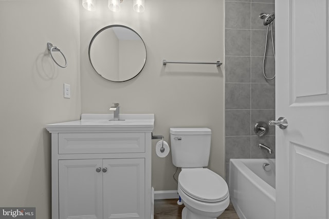 full bath with toilet, baseboards, shower / washtub combination, and vanity