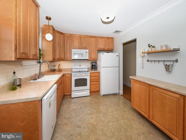 kitchen featuring crown molding, white appliances, a sink, and tasteful backsplash