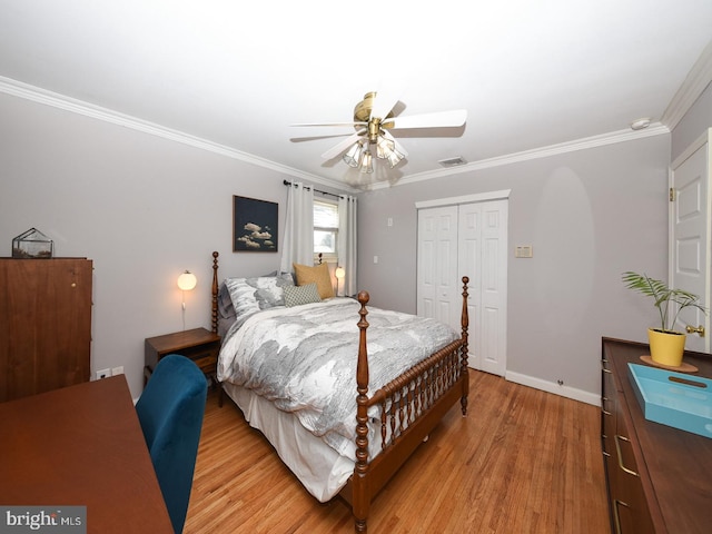 bedroom featuring a closet, visible vents, crown molding, and light wood-style flooring