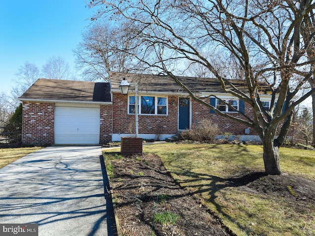 view of front of home featuring driveway, a front yard, a garage, and brick siding