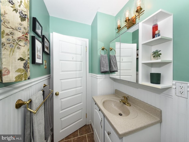 bathroom with tile patterned floors, vanity, and wainscoting