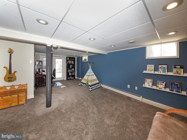 recreation room with baseboards, a drop ceiling, carpet, baseboard heating, and recessed lighting