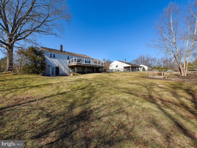 view of yard featuring a deck and fence