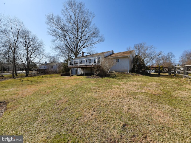 view of yard with fence and a wooden deck