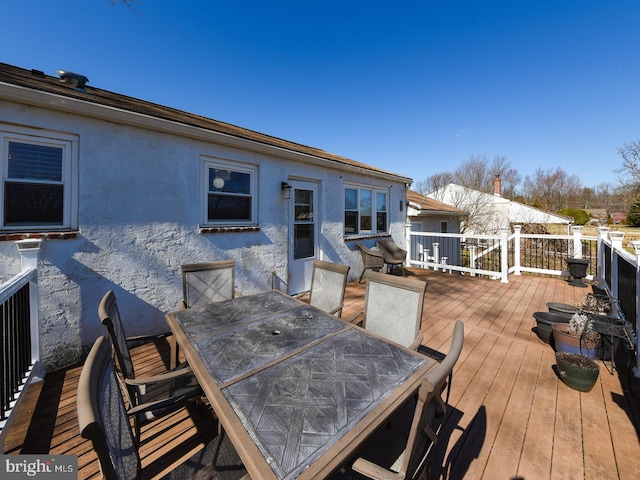 deck with outdoor dining area