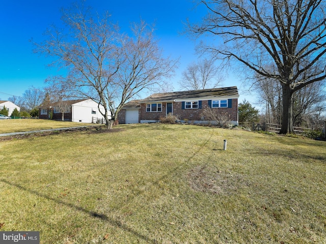 view of front of home with a garage, fence, a front lawn, and brick siding