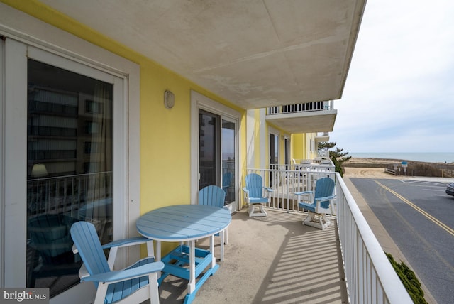 balcony with a sunroom and a water view