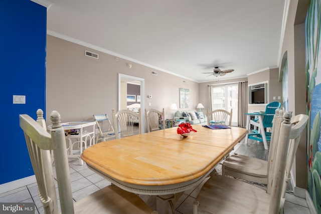 dining area featuring light tile patterned floors, ceiling fan, visible vents, and ornamental molding