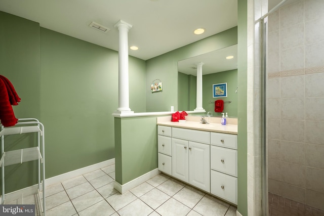 bathroom with a stall shower, visible vents, tile patterned flooring, vanity, and ornate columns