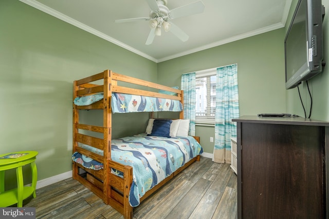 bedroom featuring ornamental molding, baseboards, and wood finished floors