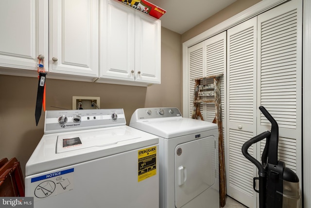 laundry room with cabinet space and washing machine and dryer