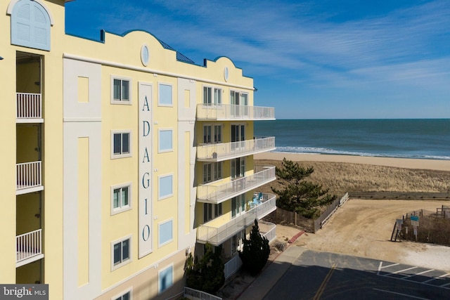 view of property featuring a view of the beach and a water view