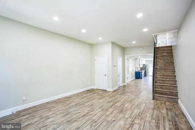 interior space with stairs, recessed lighting, wood finished floors, and baseboards