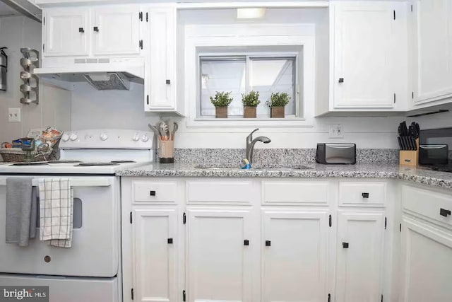 kitchen with white electric range oven, light stone countertops, a sink, under cabinet range hood, and white cabinetry