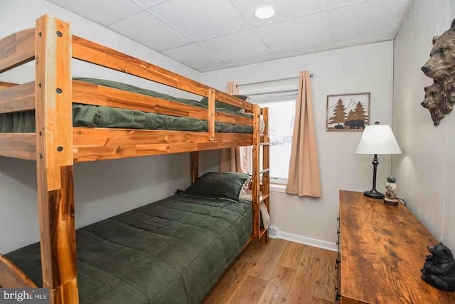 bedroom featuring baseboards and wood finished floors