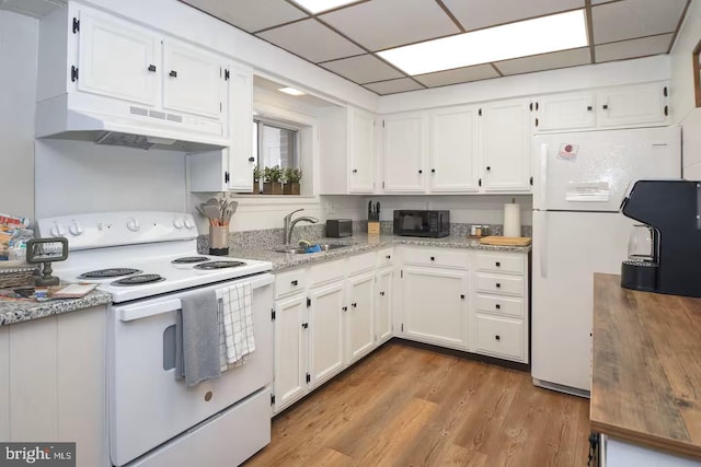 kitchen with white cabinetry, white appliances, under cabinet range hood, and a sink