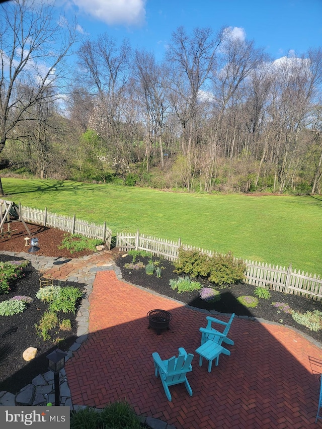 view of patio with a fenced backyard and a fire pit