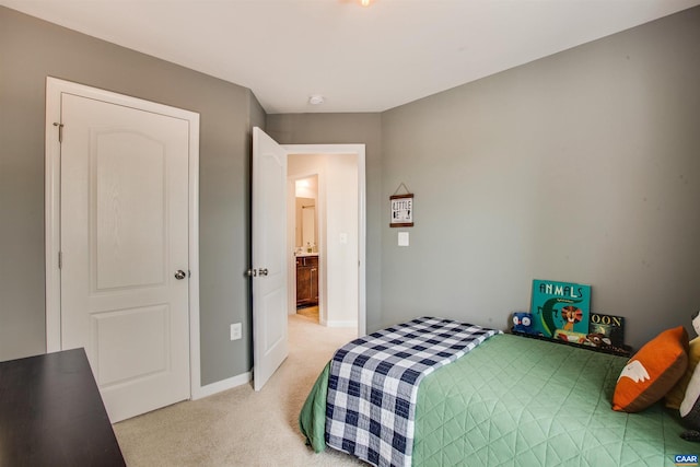 bedroom with baseboards and light colored carpet