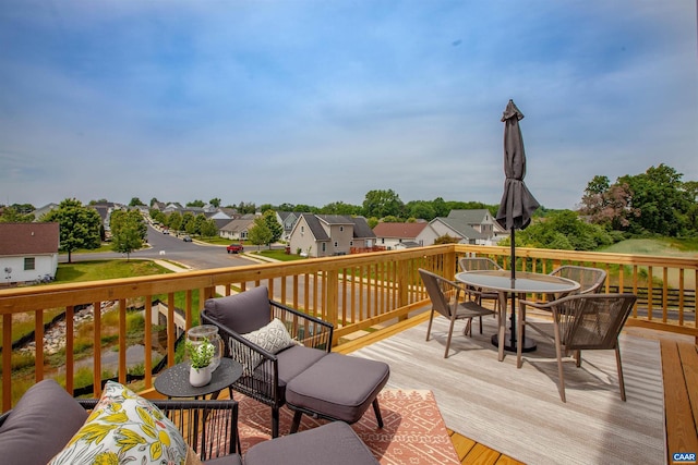 deck with a residential view and outdoor dining area