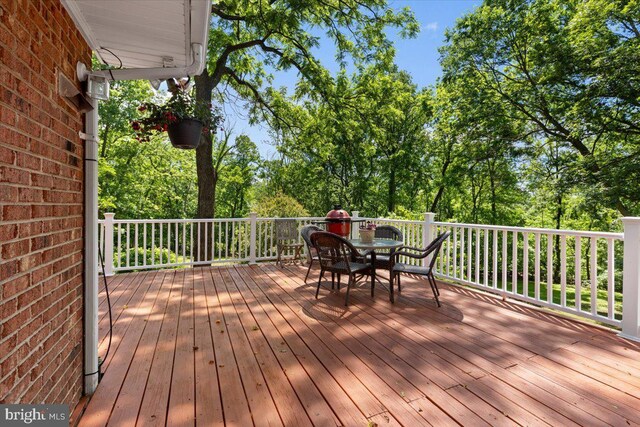 38577 Goose Creek Ln, Leesburg, VA 20175 - wooden deck with outdoor dining area and view of scattered trees