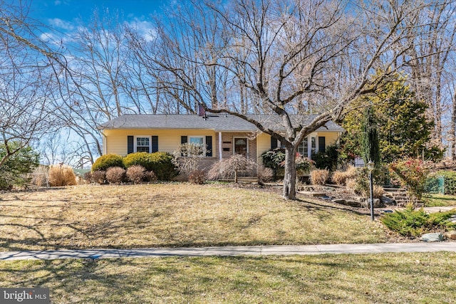 ranch-style house with a chimney and a front yard