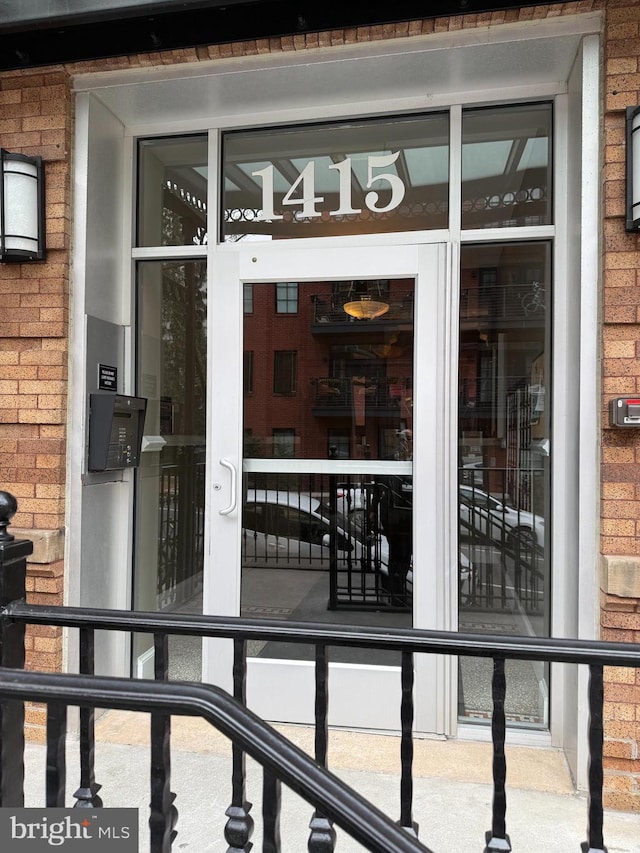 property entrance featuring brick siding