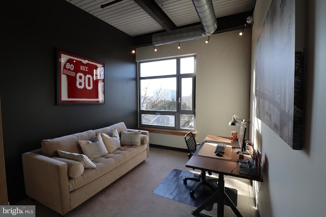 office area with beamed ceiling, baseboards, track lighting, and carpet flooring