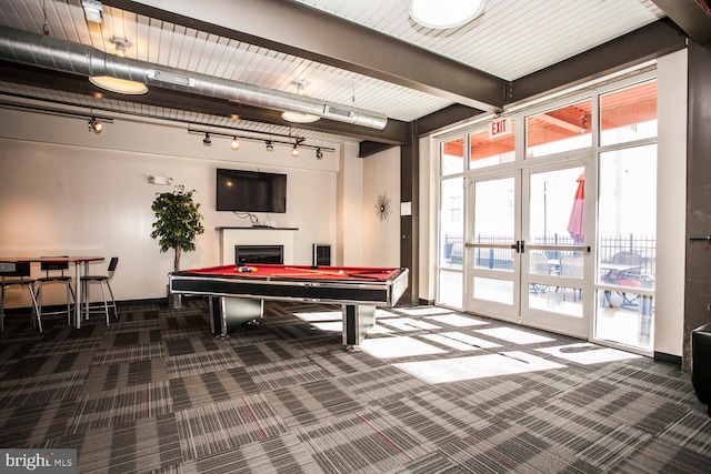 game room featuring beamed ceiling, french doors, carpet, a fireplace, and baseboards