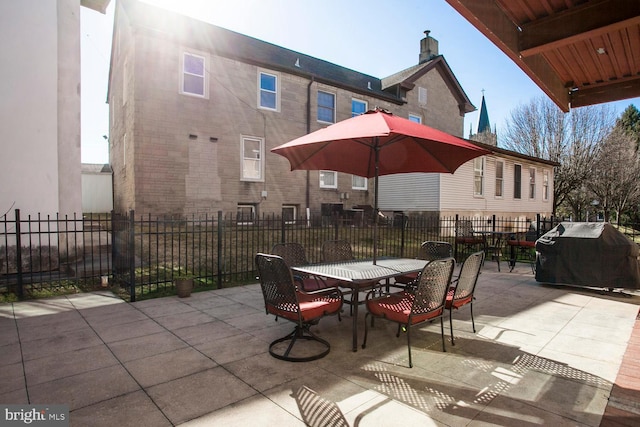 view of patio / terrace featuring outdoor dining area, a grill, and fence