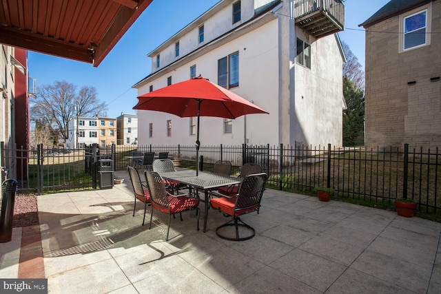 view of patio with outdoor dining space and fence