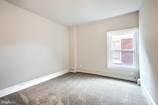 unfurnished room with baseboard heating, carpet flooring, and baseboards