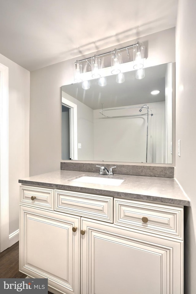 bathroom with vanity and wood finished floors