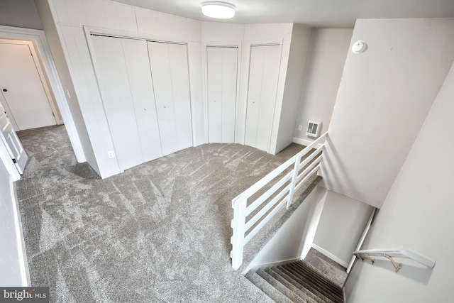 stairs with visible vents and carpet