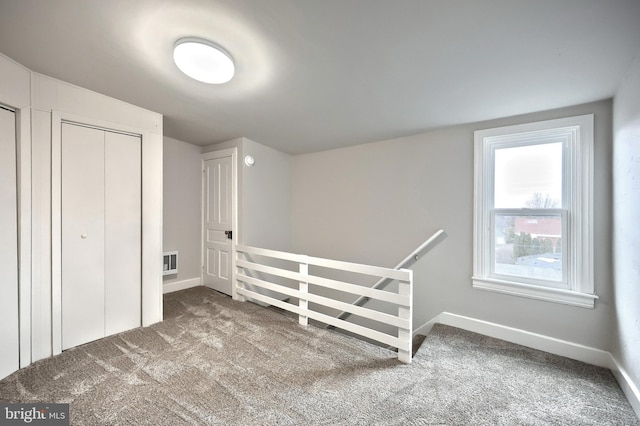 additional living space with visible vents, baseboards, and carpet