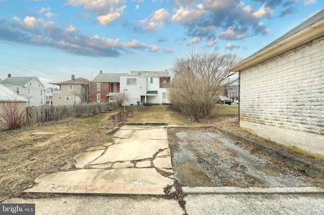 view of yard featuring fence and a residential view