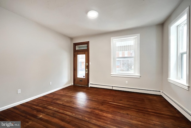 entryway with dark wood finished floors, plenty of natural light, and a baseboard radiator