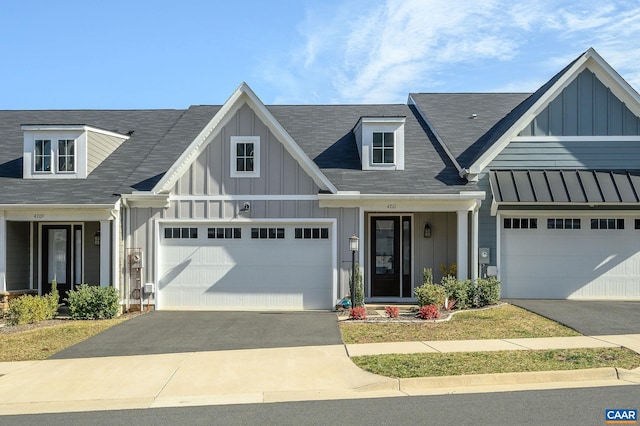 view of front of property featuring aphalt driveway, board and batten siding, and an attached garage