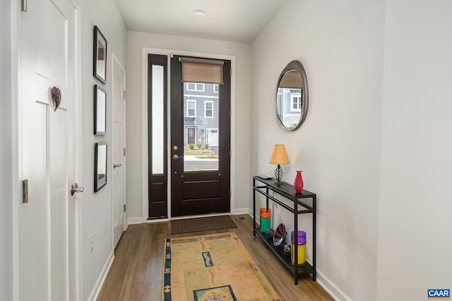 entrance foyer featuring baseboards and wood finished floors