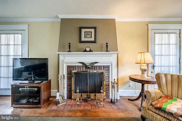 living area featuring a fireplace, a wealth of natural light, and ornamental molding