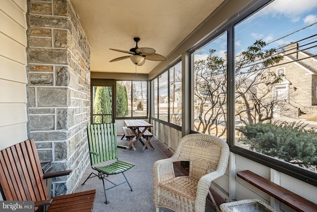 sunroom / solarium with a ceiling fan